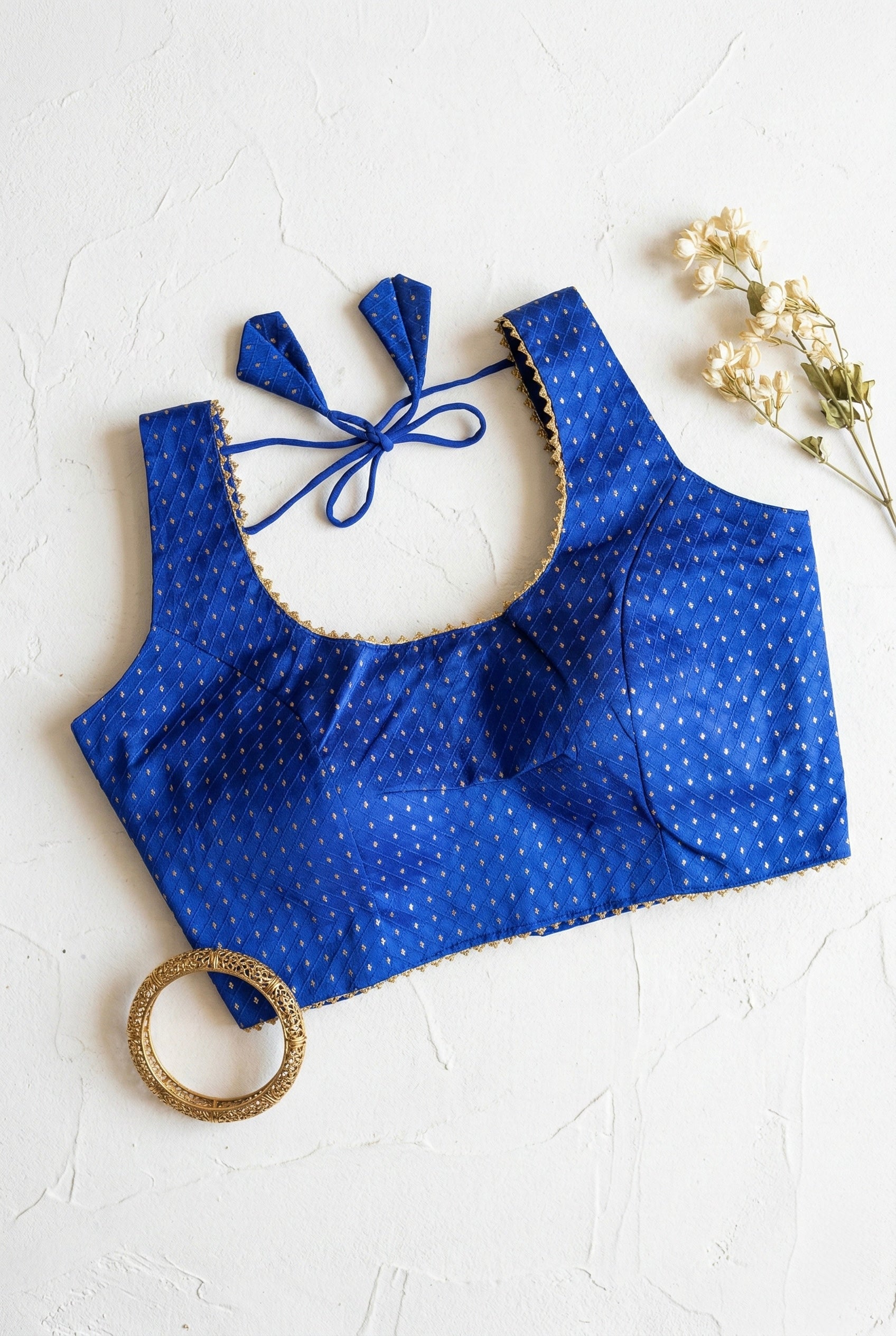 Silk blouse with gold lace detailing and zari bhutta