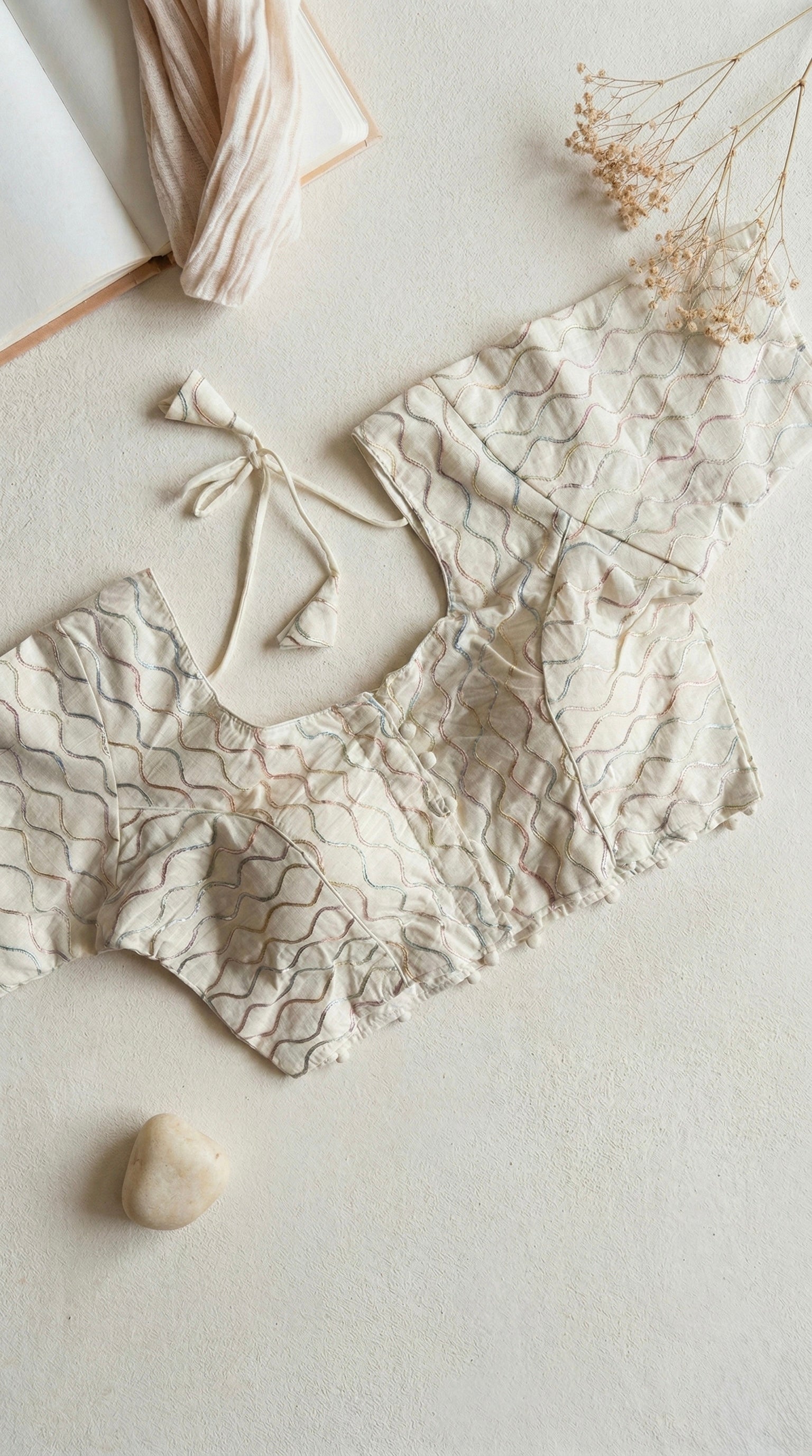 Khadi half sleeve padded blouse in wavy embroidery pattern