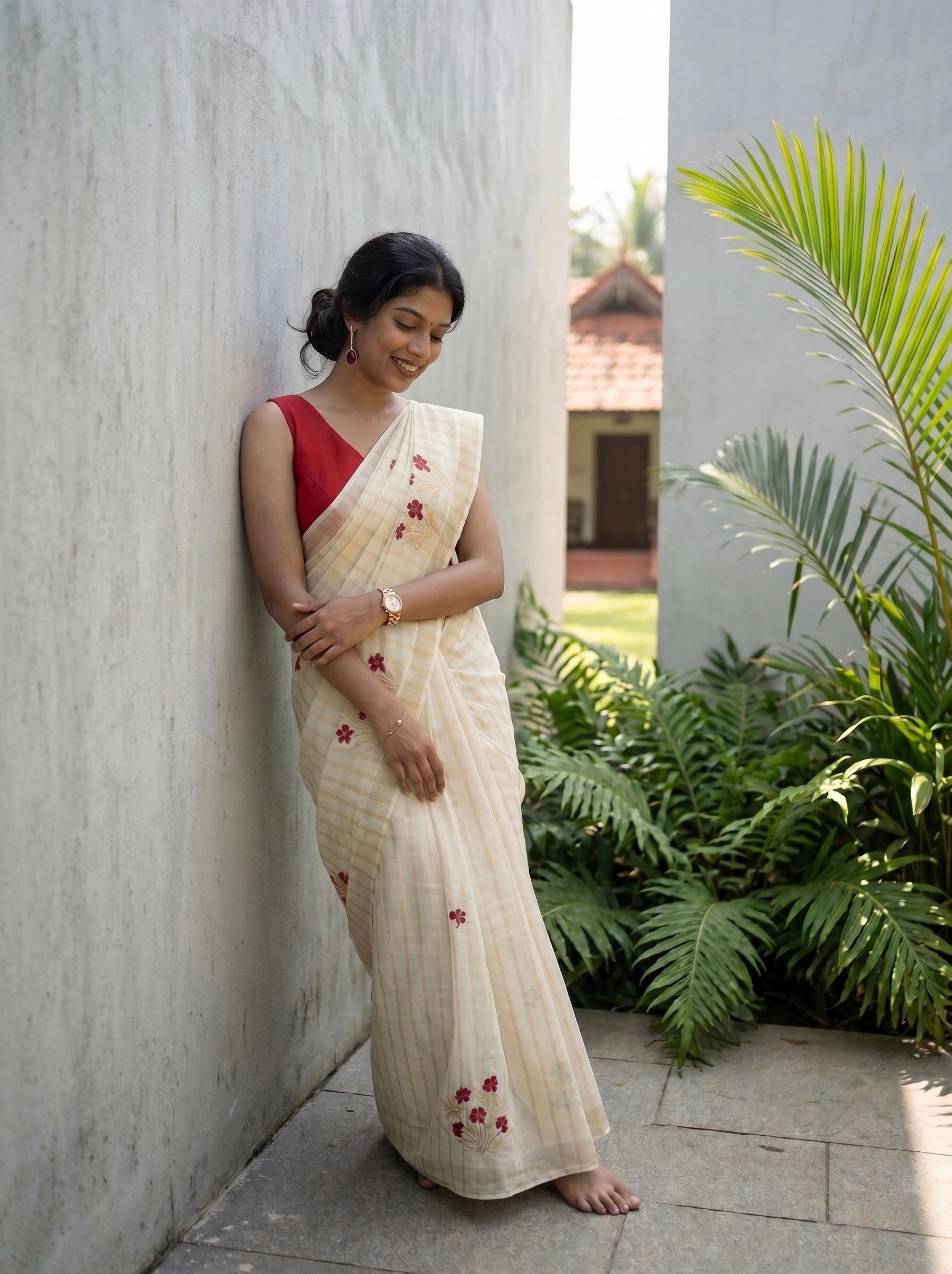 Kerala saree in gold stripes and thread floral embroidery.